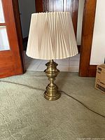 Full view of brass lamp with shade