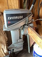Full view of Evinrude outboard motor mounted on shelf