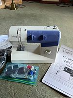 Sewing machine with foot pedal, manuals, thread bag