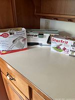 All three boxed kitchen appliances on countertop