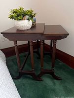 Two wooden nesting side tables positioned together