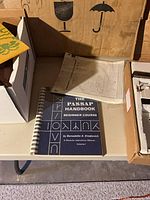 Passap Handbook and punch card on table