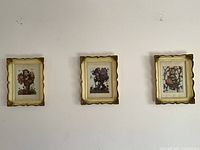 All three framed Hummel prints hung on wall