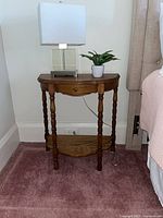 Full view of wooden side table beside bed