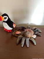 Puffin and spider Beanie Babies on surface