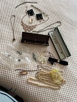 Overview of all jewelry pieces spread on bed