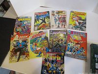 All nine comic books laid out showing covers