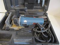 Freud JS100 biscuit joiner in case with cord and fence visible