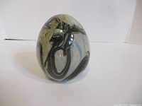 Front view of glass egg showing swirl pattern