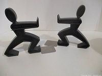 Two sculptural figure bookends facing each other