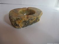 Angled view of alabaster ashtray showing exterior veining and bowl