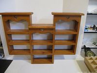 Front view of pine shelf showing cubbies and heart cut-outs