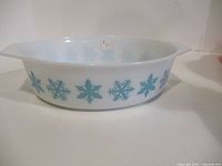 Side view showing turquoise snowflake pattern and handles