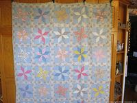 Full view of quilt hanging showing overall pattern and size