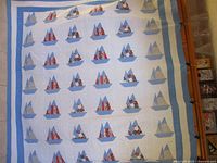 Full view of quilt showing sailboat pattern and borders