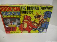 Front of Rock 'Em Sock 'Em Robots box showing graphics, age rating, player count