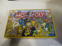 Front of Simpsons Monopoly box showing title and characters