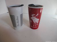 Front view of both travel mugs displaying designs