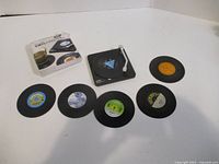 Full set showing box, holder, six coasters