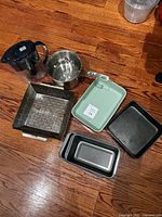 All items arranged on floor showing cookware, bakeware and Brita pitcher