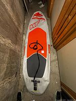 Full view of paddle board with surf leash attached