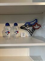 LED sign, two cocktail shakers on shelf