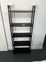 Front view of black-brown five-shelf Ikea Laiva bookcase