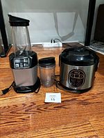 Blender base with cup and rice cooker shown together