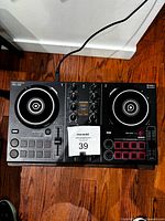 Top view of Pioneer DDJ-200 controller showing full layout and attached cable