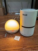 Philips Wake-Up Light illuminated next to Levoit air purifier