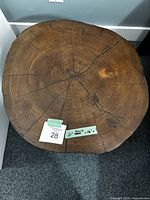 Top view showing solid wood slab with concentric growth rings and natural cracks