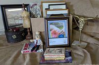 Overview of lot showing frames, mannequin, Dilbert items, cattle skull, storage box and die-cast car