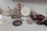 Group shot showing tureen, decanter, plates, teapot set, trinket box