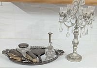 Full view of vanity items on mirrored tray with candelabra