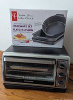 Toaster oven front view with boxed bakeware set on top