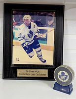 Plaque and signed puck on shelf