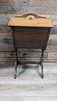 front view of closed wooden sewing stand on legs