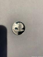 Front of silver-tone Thatcher Memorial commemorative coin