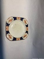 Square decorative plate showing full pattern and wear