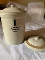 Crock with fitted lid and separate extra lid showing glazing and markings