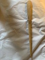 Full view of entire wooden spoon on neutral background