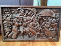Frontal view of entire carved wood panel depicting ceremonial scene