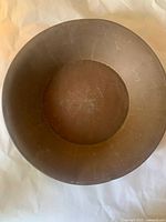 Top view of large round metal bowl showing interior and patina