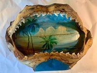 Front view of shark jaw showing teeth and interior painted tropical scene