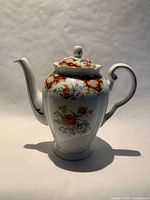 Profile view of Windsor bone china teapot showing pattern and lid