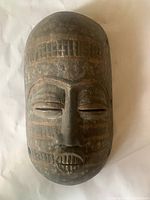 Front view of carved wood mask showing overall design and condition