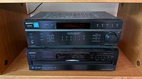 Front view of Onkyo DX-C390 6-disc CD changer (bottom unit) showing display and control panel