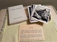 Closed white slip-case labeled Ansel Adams Images of Yosemite beside stack of photo greeting cards and insert