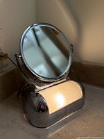Mirror with light on showing overall design