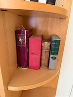 Five vintage hardcover books on shelf